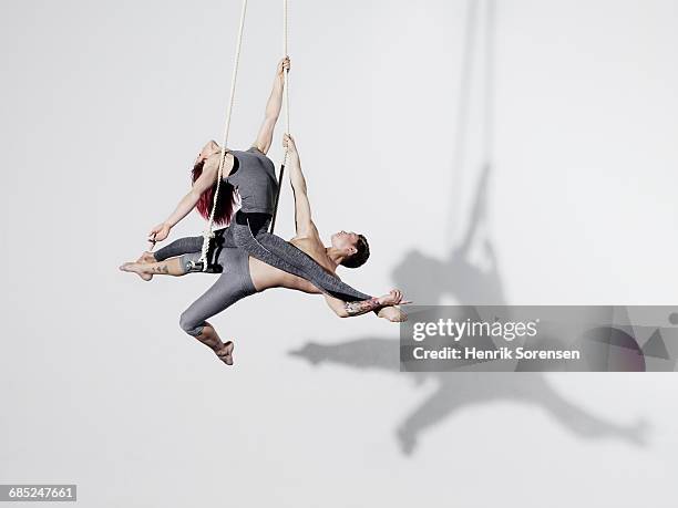 circus artists in trapeze - trapeze artist stock pictures, royalty-free photos & images