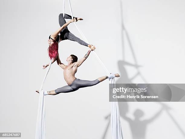circus artists in silks - show of strength stock-fotos und bilder