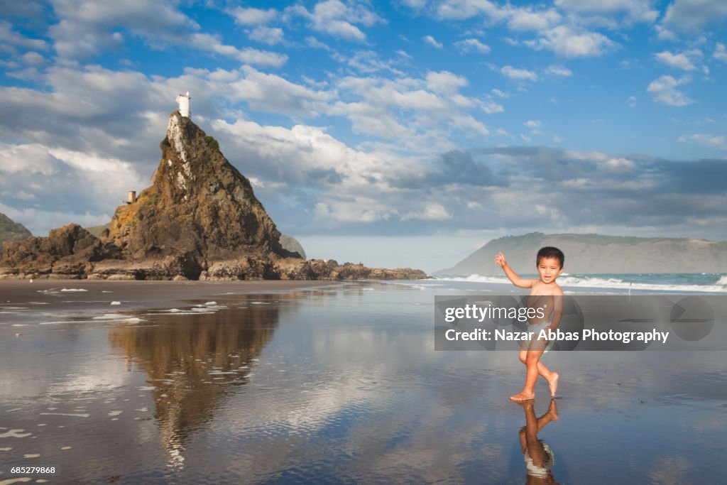 Kid Wearing Diaper Enjoying On Beach.
