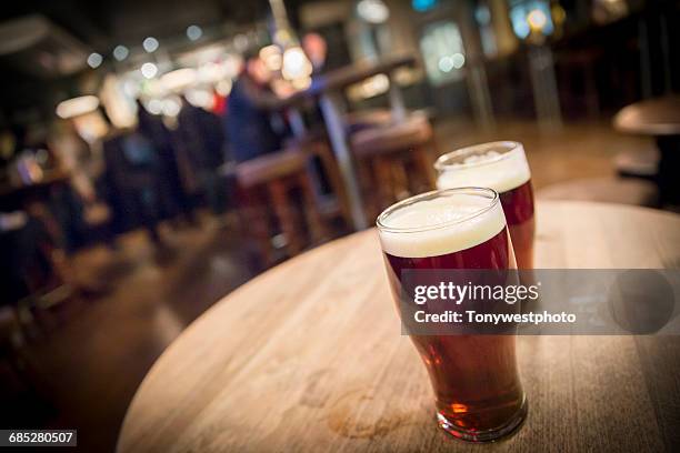 pints of ale in a pub in the city of london - british pub stock-fotos und bilder
