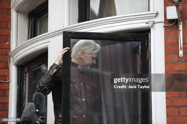 Julian Assange makes his way back indoors after speaking to the media from the balcony of the Embassy Of Ecuador on May 19, 2017 in London, England....