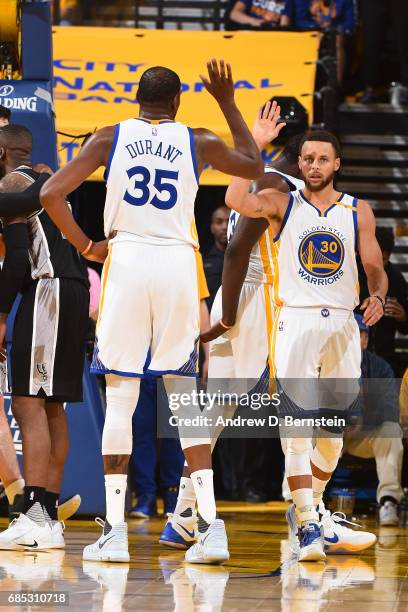 Kevin Durant and Stephen Curry of the Golden State Warriors high five in Game One of the Western Conference Finals against the San Antonio Spurs...