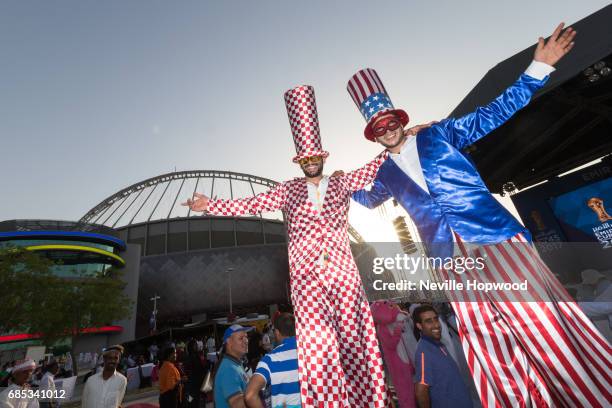 Ans enjoy the entertainment of the stiltwalkers in the fan zone at Khalifa International Stadium on May 19, 2017 in Doha, Qatar. Qatar's Supreme...