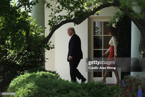 President Donald Trump and first lady Melania Trump come out from the Oval Office prior to their departure from the White House May 19, 2017 in...