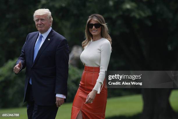 President Donald Trump and first lady Melania Trump walk on the South Lawn prior to their departure from the White House May 19, 2017 in Washington,...