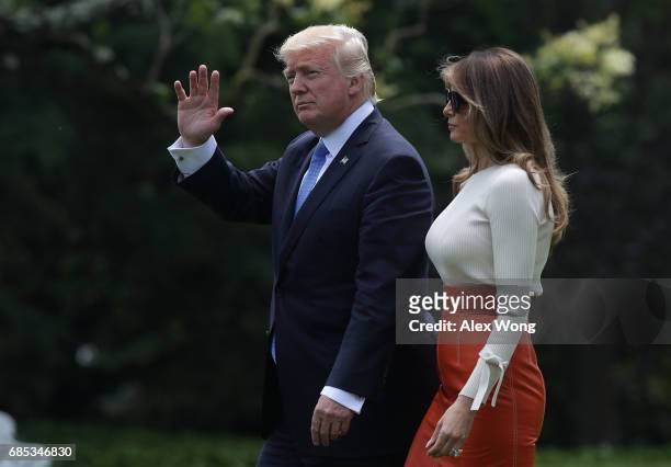 President Donald Trump and first lady Melania Trump walk on the South Lawn prior to their departure from the White House May 19, 2017 in Washington,...
