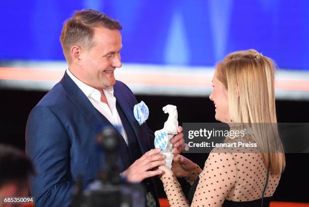 Nadja Uhl hands over the award to Devid Striesow, winner of the category 'Best Male Actor', during the Bayerischer Fernsehpreis 2017 show at...