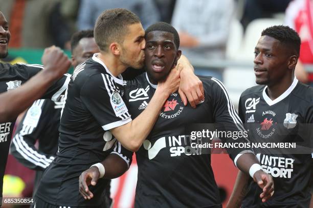 Amiens teammates celebrate after Amiens' forward Aboubakar Famara scored a goal during the Ligue 2 Football match Reims-Amiens on May 19 2017 at the...