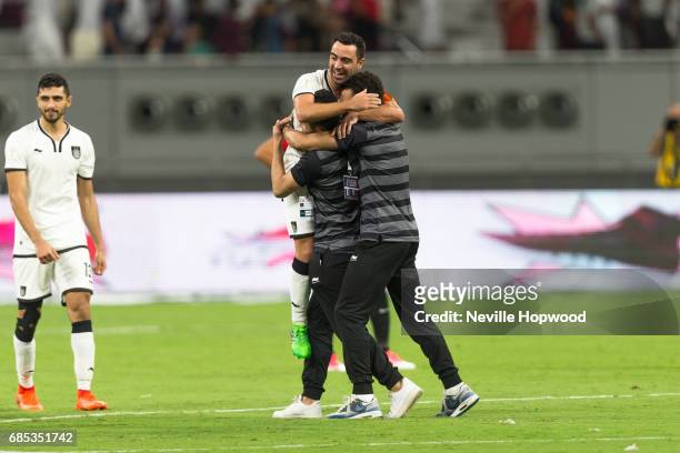 Xavi, Captain of Al Sadd, is congratulated at the final whistle by team mates on winning the Emir Cup for Al Sadd 2-1 against Al Rayyan at Khalifa...