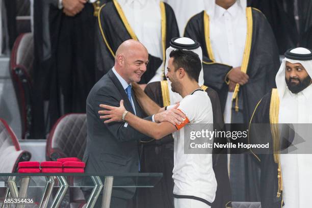 Gianni Infantino, FIFA Prsident, congratulates Xavi, captain of Al Sadd on winning the 2017 Emir Cup at Khalifa International Stadium on May 19, 2017...