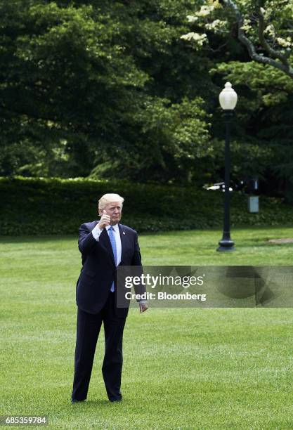 President Donald Trump gives a thumbs up while walking towards Marine One on the South Lawn of the White House in Washington, D.C., U.S., on Friday,...