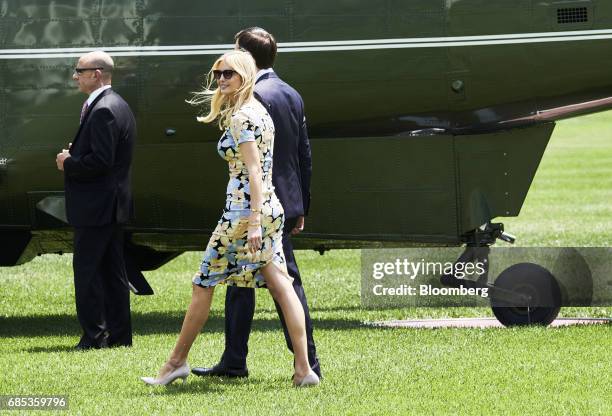 Jared Kushner, senior White House adviser, and Ivanka Trump, assistant to U.S. President Donald Trump, walk towards Marine One on the South Lawn of...