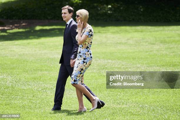 Jared Kushner, senior White House adviser, and Ivanka Trump, assistant to U.S. President Donald Trump, walk towards Marine One on the South Lawn of...