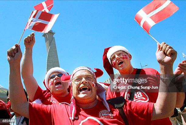 Fans of the Denmark soccer team celebrate before a game against France during the 2002 World Cup at Incheon stadium June 11, 2002 in Incheon, South...