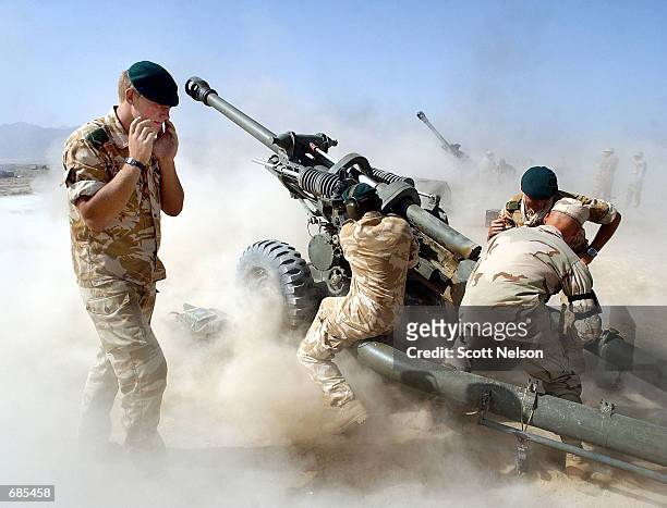 British and American forces fire 105mm artillery rounds during a live fire exercise June 11, 2002 at Bagram Airbase in Afghanistan. Coalition troops...