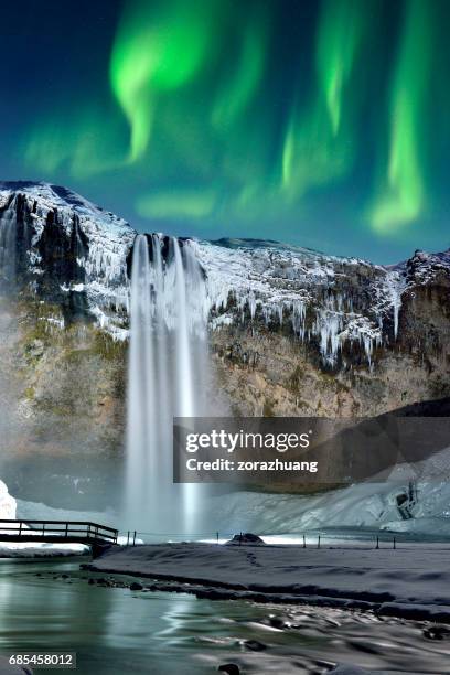 skogafoss waterfall and green aurora, iceland - skogafoss waterfall stock pictures, royalty-free photos & images