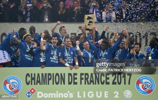 Strasbourg's team hold their French L2 champion trophy after winning the French L2 football match between Strasbourg and Bourg-en-Bresse at the...