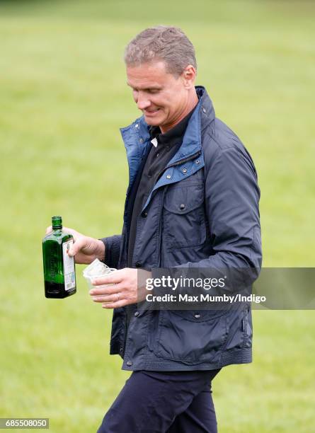 David Coulthard hands out drinks as he attends the 5th edition of the 'ISPS Handa Mike Tindall Celebrity Golf Classic' at The Belfry on May 19, 2017...