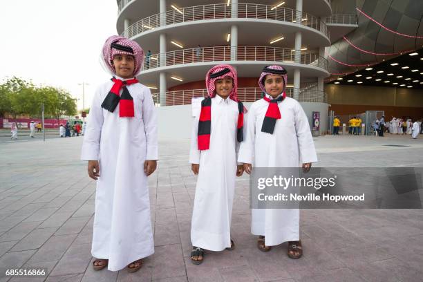 Young Al Rayyan fans pose outside the Khalifa International Stadium ahead of the Emir Cup at Khalifa International Stadium on May 19, 2017 in Doha,...