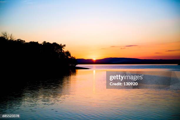 before the sun dropped - sunrise over water stock pictures, royalty-free photos & images