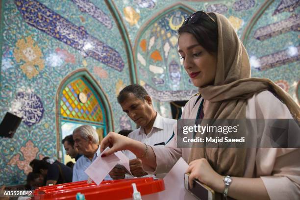 Iranian voters cast their ballots for the presidential and municipal council election on May 19, 2017 in the city of Qom, south of the capital...