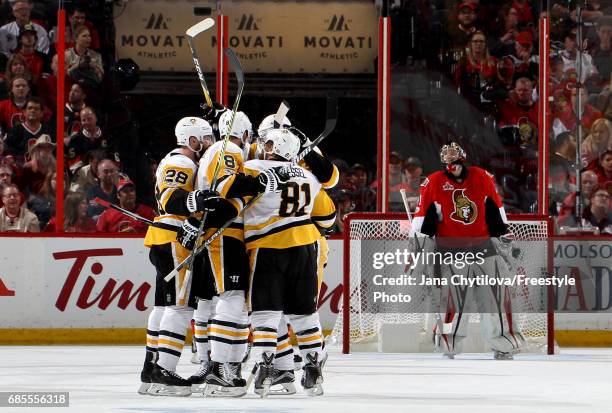 Brian Dumoulin of the Pittsburgh Penguins celebrates with his teammates after scoring a goal against Craig Anderson of the Ottawa Senators during the...