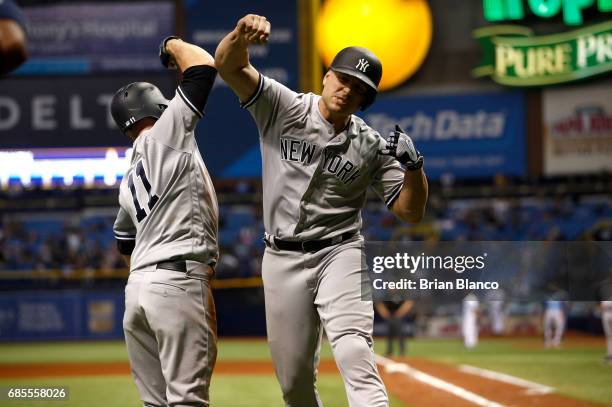 Matt Holliday of the New York Yankees celebrates at home plate with Brett Gardner after both scoring off of Holliday's two-run home run during the...