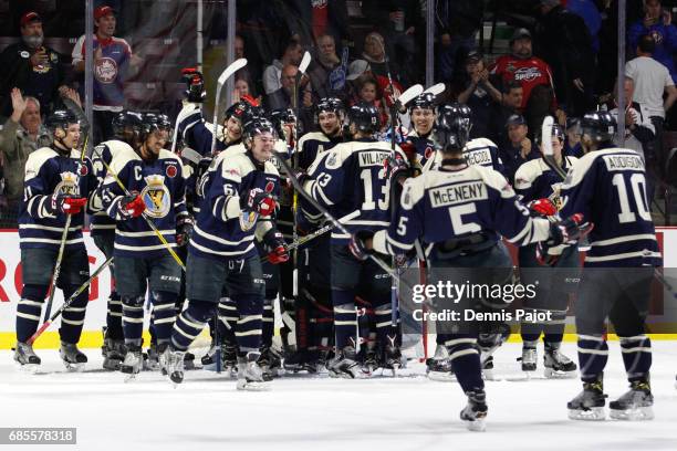 The Windsor Spitfires celebrate their 3-2 win over the Saint John Sea Dogs on May 19, 2017 during Game 1 of the Mastercard Memorial Cup at the WFCU...