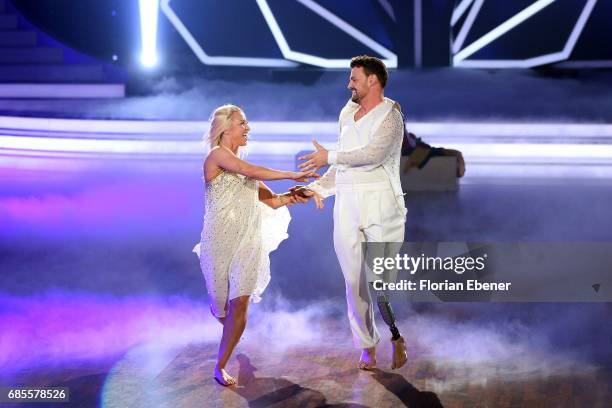 Heinrich Popow and Kathrin Menzinger perform on stage during the 9th show of the tenth season of the television competition 'Let's Dance' on May 19,...