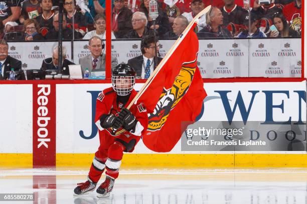 Scotiabank skater takes to the ice carrying a flag during player introductions prior to Game Four of the Eastern Conference Finals opposing the...