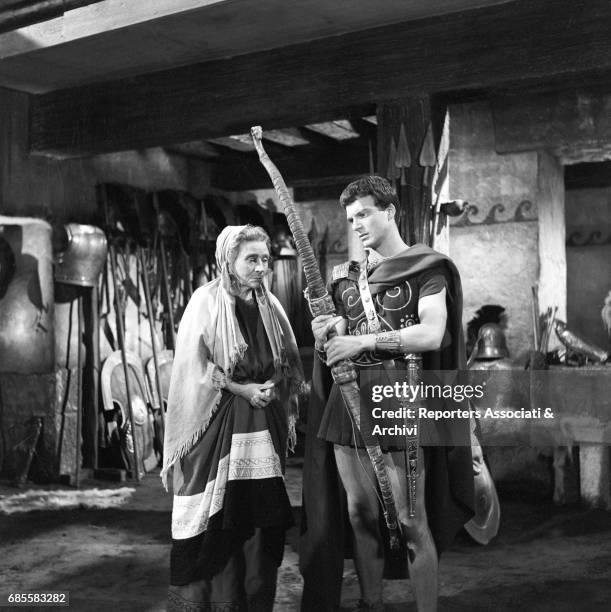 Italian actor Franco Interlenghi, as Telemachus, holding a bow. Near to him, actress Sylvie as Euriclea in the film Ulysses, directed by Mario...