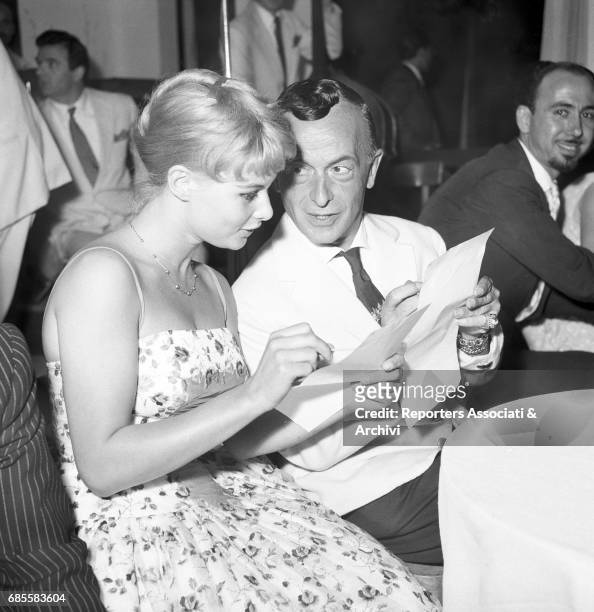 Italian actress Marisa Allasio with famous dressmaker Emilio Federico Schuberth during the beauty pageant 'Miss Belvedere delle Rose' , in the Roman...