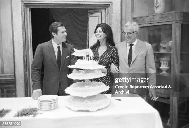 Italian actor Marcello Mastroianni celebrating, on the set of Marriage Italian Style, the birtday of actress Sophia Loren with her husband, producer...