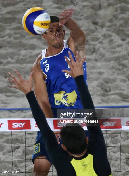 Alvaro Morais Filho of Brazil spikes the ball against Andre Loyola Stein of Brazil during the main draw match at Olympic Park during day two of the...