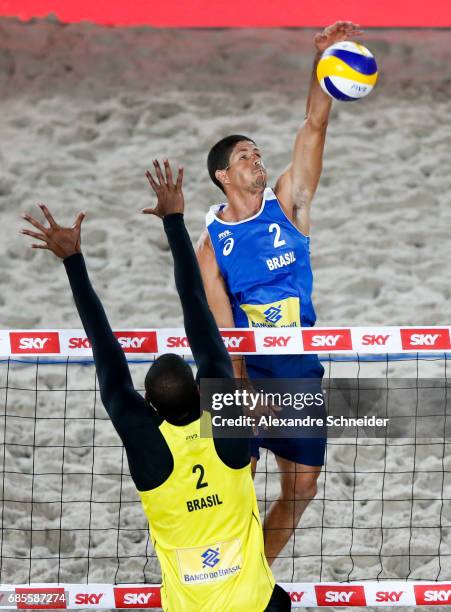 Alvaro Filho of Brazil spikes the ball against Evanro Goncalves of Brazil during the main draw match against Brazil at Parque Olimpico during day two...