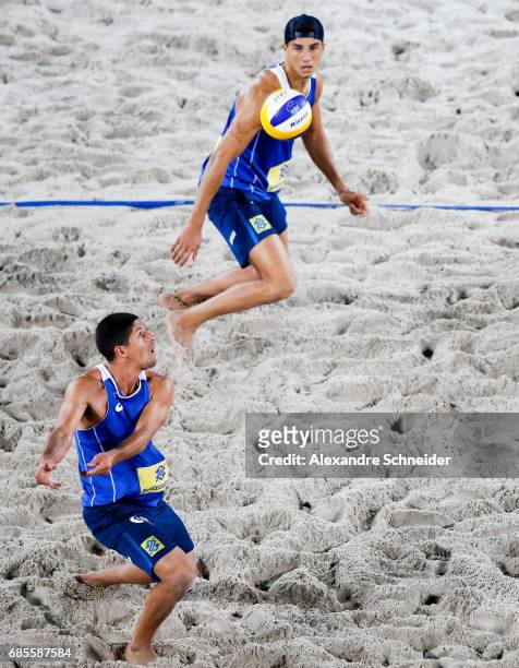 Alvaro Filho and Saymon Barbosa of Brazil in action during the main draw match against Brazil at Parque Olimpico during day two of the FIVB Beach...