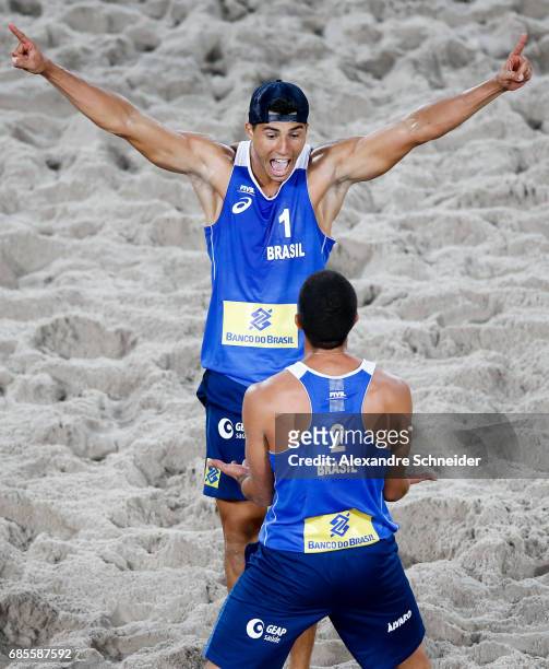 Alvaro Filho and Saymon Barbosa of Brazil celebrate a point during the main draw match against Brazil at Parque Olimpico during day two of the FIVB...