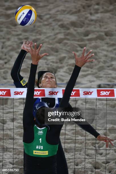 Larissa Frana Maestrini of Brazil spikes the ball against Taliqua Clancy of Australia during the main draw match at Olympic Park during day two of...