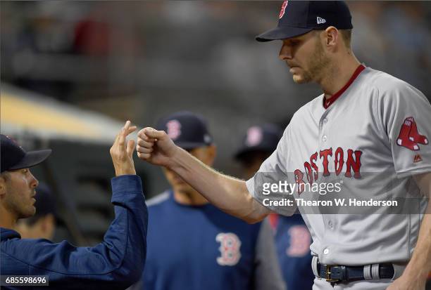 Chris Sale of the Boston Red Sox is congratulated by teammates as he returns to the dugout after striking out his tenth batter of the game against...