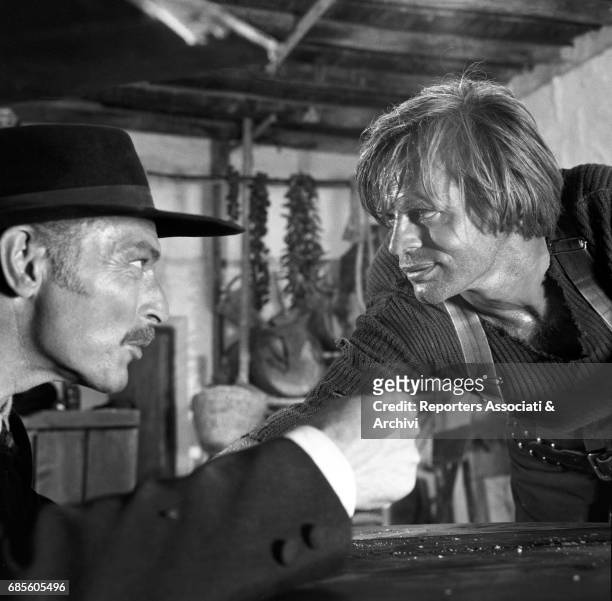 American actor Lee Van Cleef with German actor Klaus Kinski in a scene from the film 'For a Few Dollars More', directed by Sergio Leone, 1965