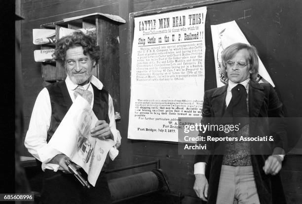 German actor Steffen Zacharias holding a gun next to German actor Klaus Kinski in Vengeance Is a Dish Served Cold. 1971