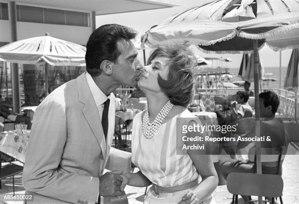 Italian actor, comedian and TV host Walter Chiari and the actress Sandra Mondaini kissing each other in a scene from the film 'Caccia al marito'...