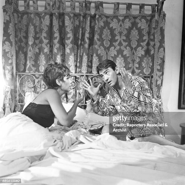 Italian actor, comedian and TV host Walter Chiari and Italian actress Lea Massari arguing on a bed in the anthology movie directed by Nanni Loy "Made...