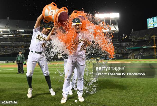 Mark Canha of the Oakland Athletics is soaked with gatorade by Adam Rosales after Canha hit a walk off solo home run to defeat the Boston Red Sox 3-2...