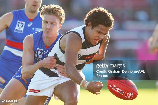 Jamaine Jones of Geelong is tackled during the round six VFL match between the Footscray Bulldogs and the Geelong Cats at Whitten Oval on May 20,...