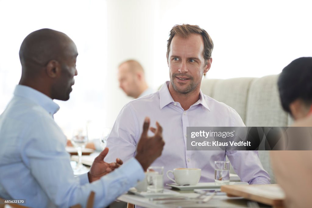 Businesspeople having conversations at restaurant