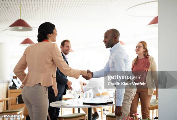 businesspeople making handshakes, at restaurant - women business lunch stock pictures, royalty-free photos & images