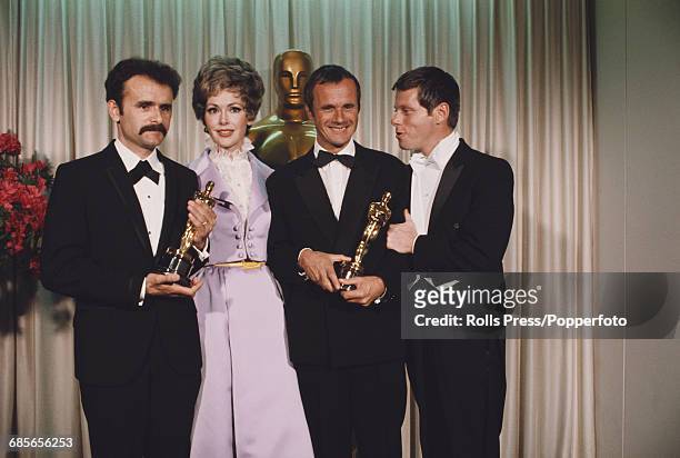 American actors Barbara Rush and Robert Morse pictured with producers Trevor Greenwood and Pierre Schoendorfer holding their respective Academy...
