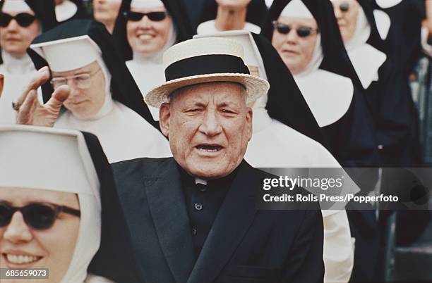 Cardinal Richard Cushing , Archbishop of Boston, pictured wearing a boater hat and surrounded by a gathering of nuns in 1968.