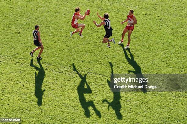 Gary Rohan of the Swans marks the ball against Dylan Roberton of the Saints during the round nine AFL match between the St Kilda Saints and the...